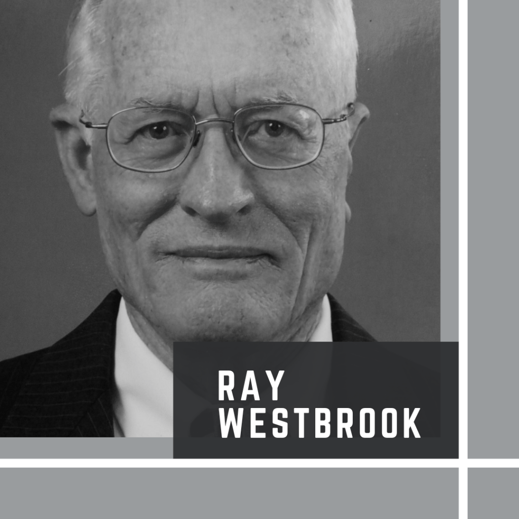 Image of an older man smiling at the camera who is wearing glasses. The words Ray Westbrook are on the image. 