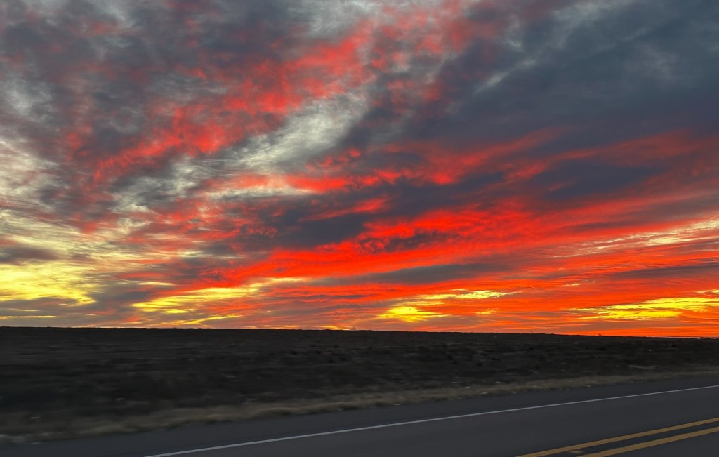 Sunrise with clouds. Clouds are pink, purple, orange. 